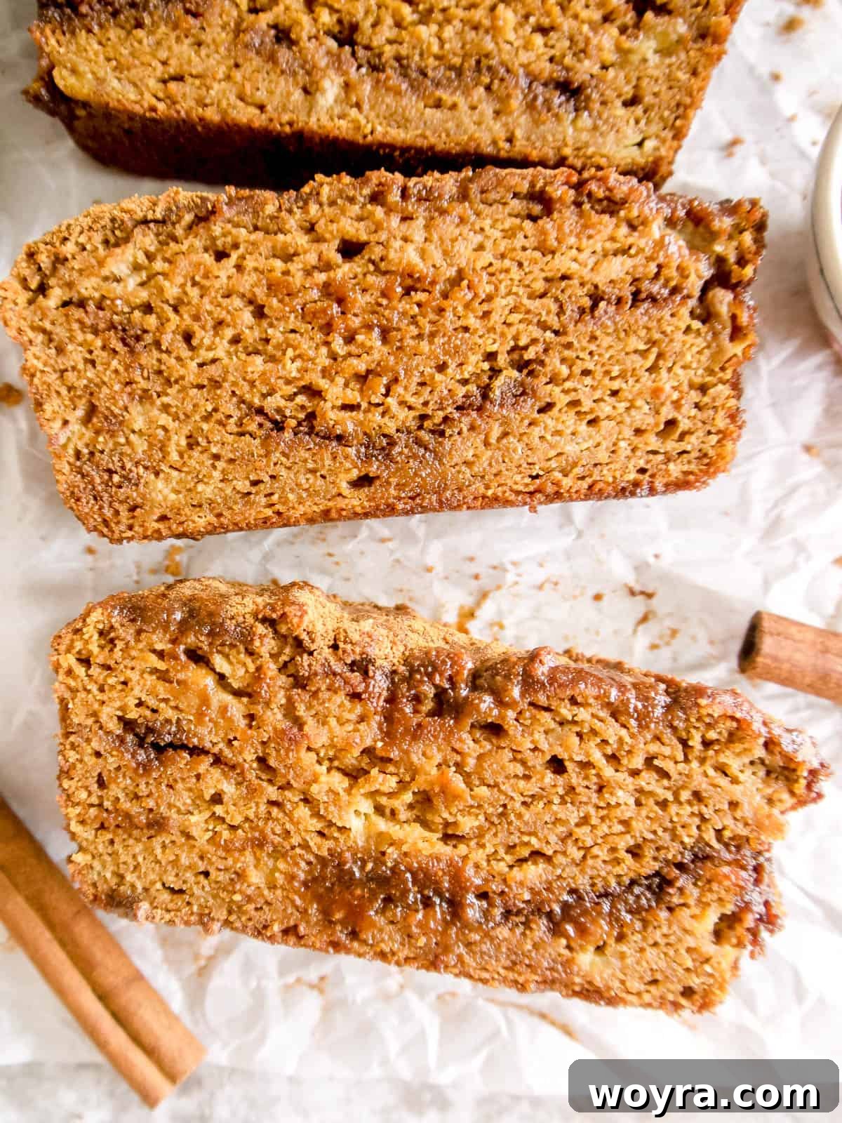 Wholesome Paleo Cinnamon Swirl Pumpkin Banana Bread 5 Individual slices of moist Paleo pumpkin banana bread, showcasing the golden crust and internal cinnamon swirls.