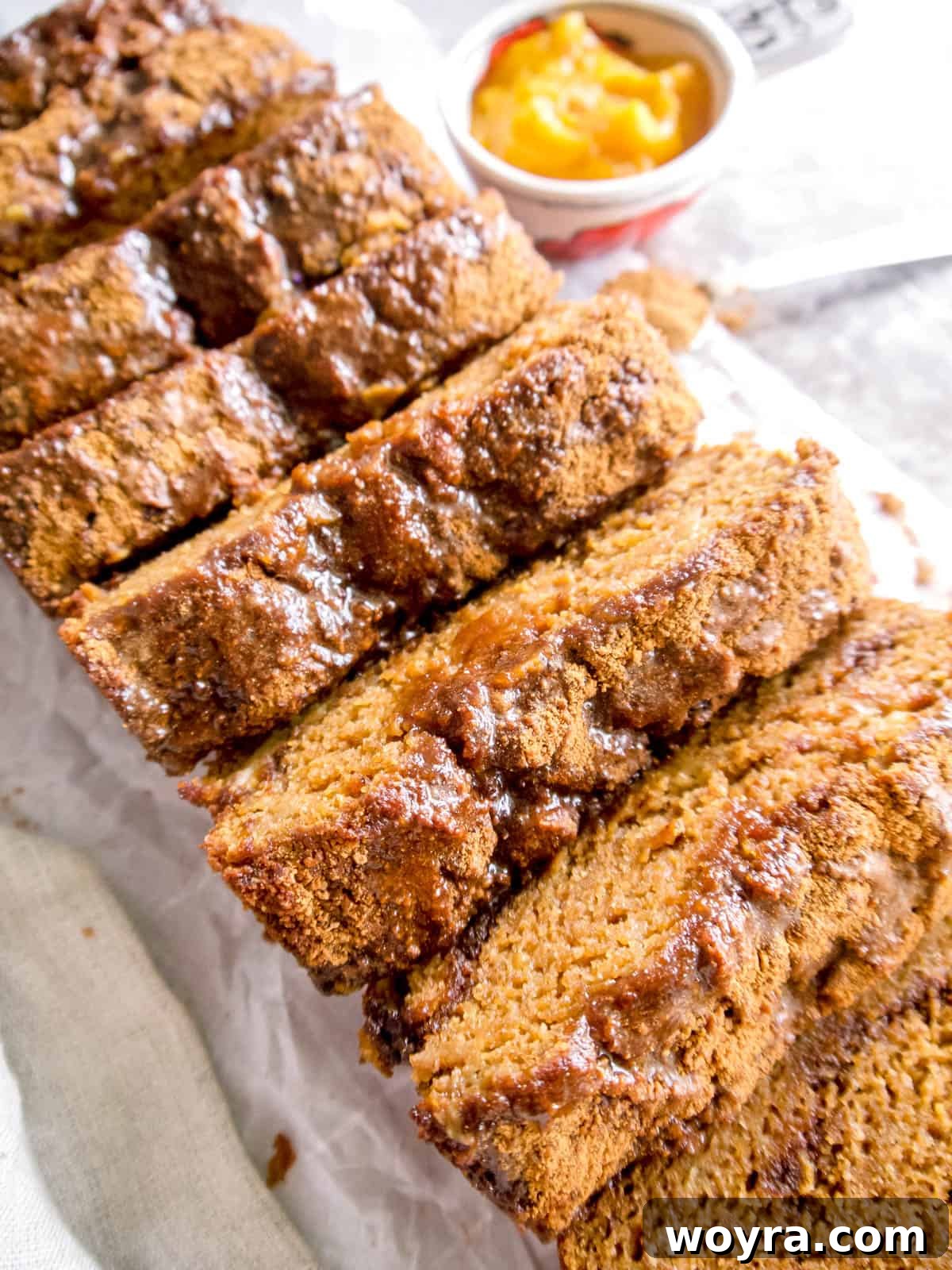 Wholesome Paleo Cinnamon Swirl Pumpkin Banana Bread 6 A freshly baked Paleo pumpkin banana bread loaf, drizzled with maple glaze and ready to be served.