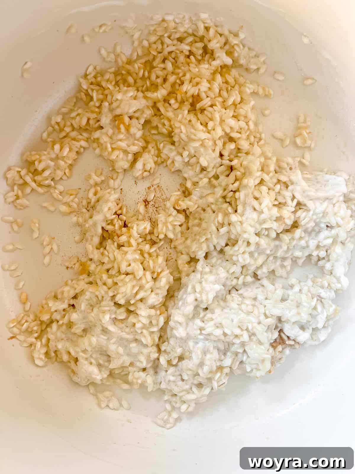 Coconut cream being stirred into the toasted rice.
