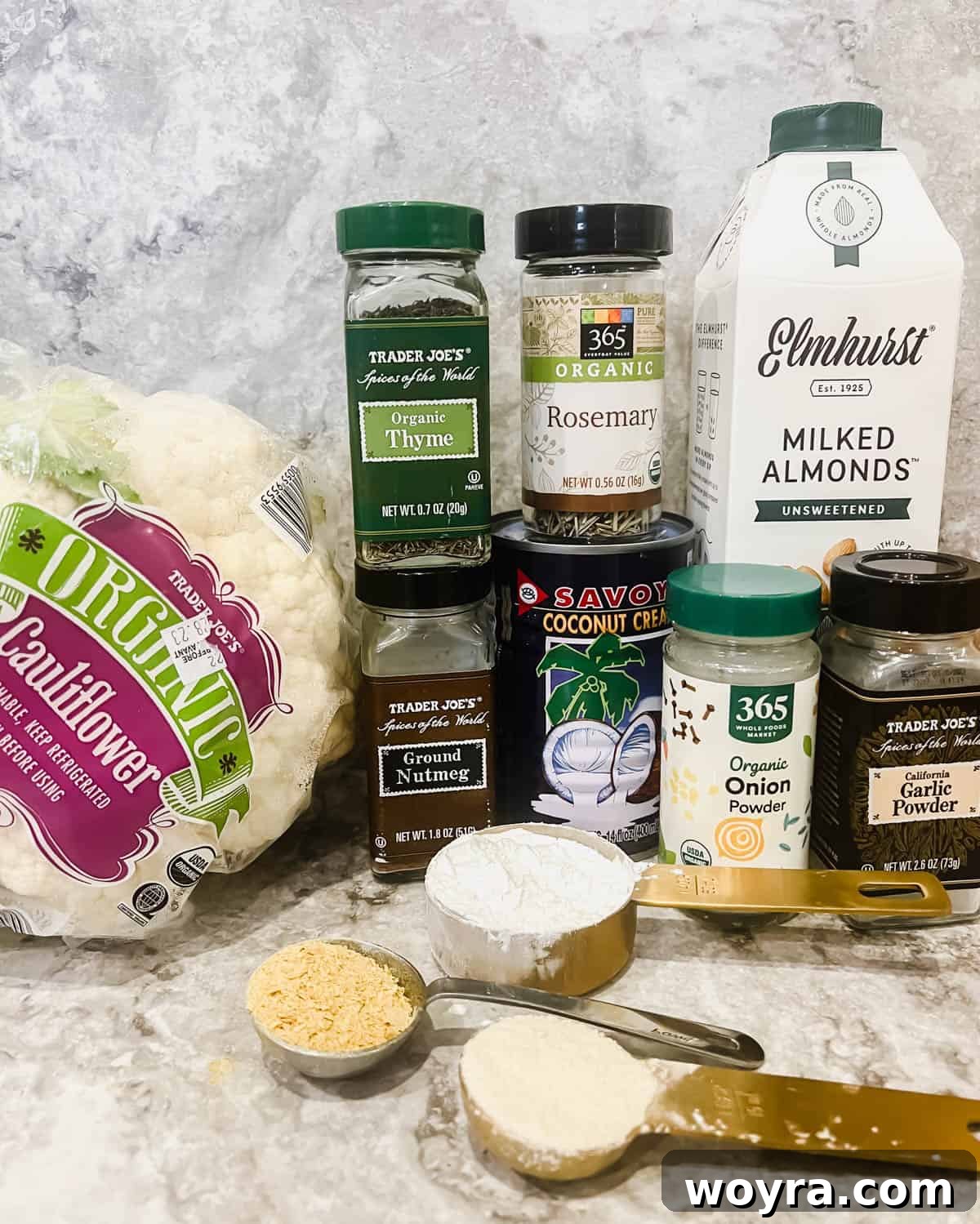 A flat lay photograph showing all the fresh ingredients needed to make a Vegan cauliflower casserole, neatly arranged on a counter.