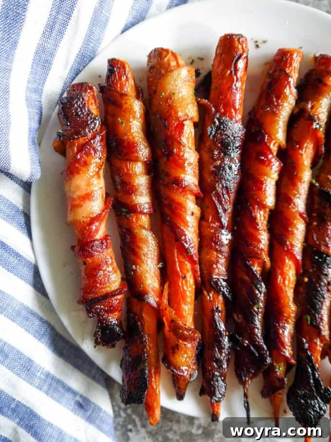 Paleo Gluten Free Maple Bacon Roasted Carrots 3 Close-up view of golden-brown Maple Bacon Wrapped Carrots, perfectly cooked and ready to serve.