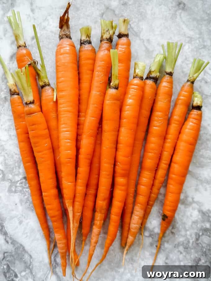 Paleo Gluten Free Maple Bacon Roasted Carrots 5 Visual guide: Starting to wrap a carrot with a strip of bacon.