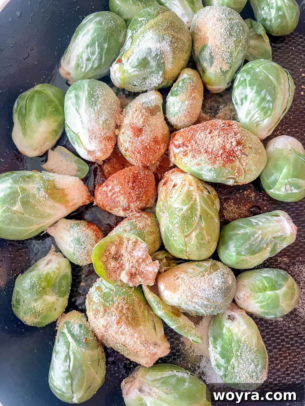 Paleo Whole30 Dairy Free Brussels Sprouts Casserole 6 Brussels sprouts tossed with various seasonings in a pan, ready for cooking.
