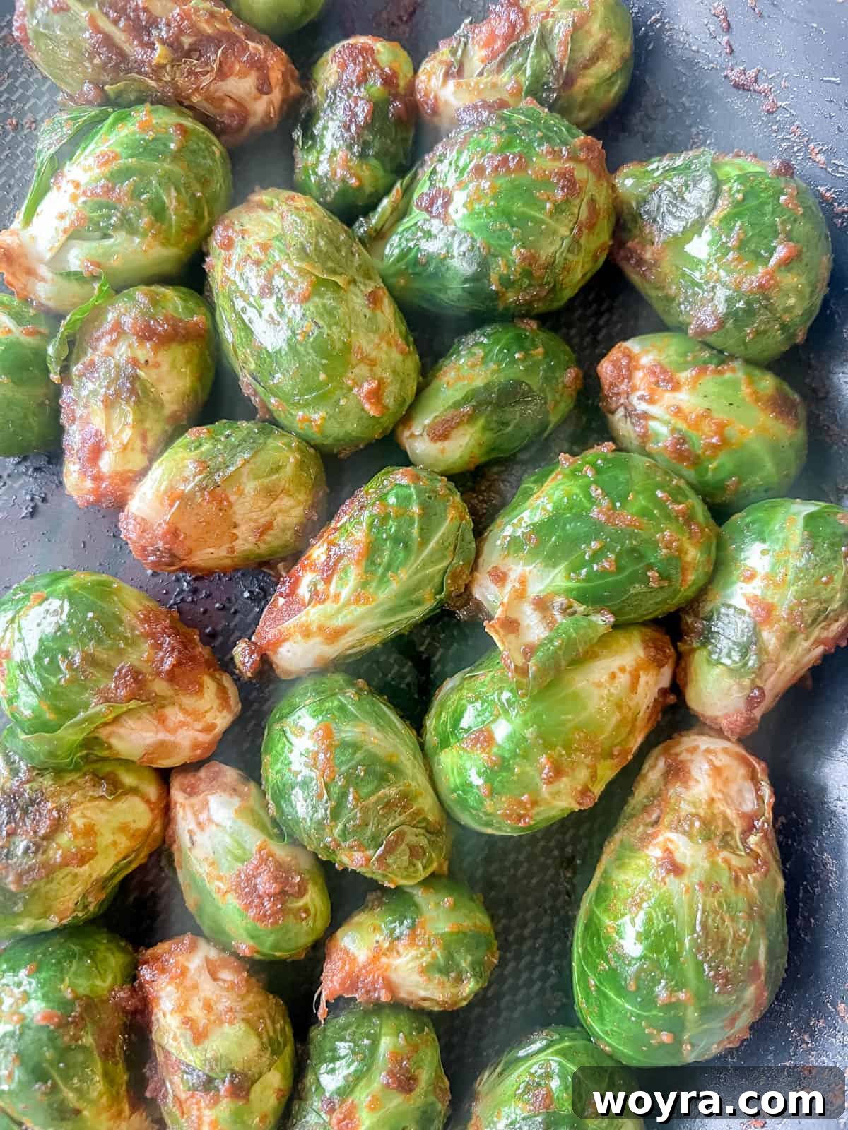 Paleo Whole30 Dairy Free Brussels Sprouts Casserole 7 Brussels sprouts gently cooking in a pan, starting to soften and absorb flavors.