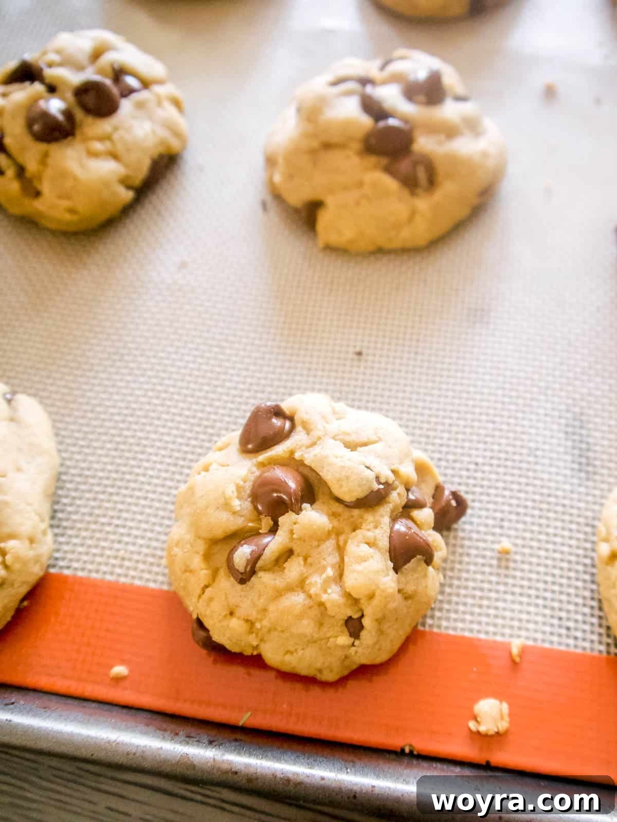 Mediterranean Chocolate Chip Jewels 8 Freshly baked olive oil chocolate chip cookies cooling on a wire rack, steam gently rising, promising deliciousness.
