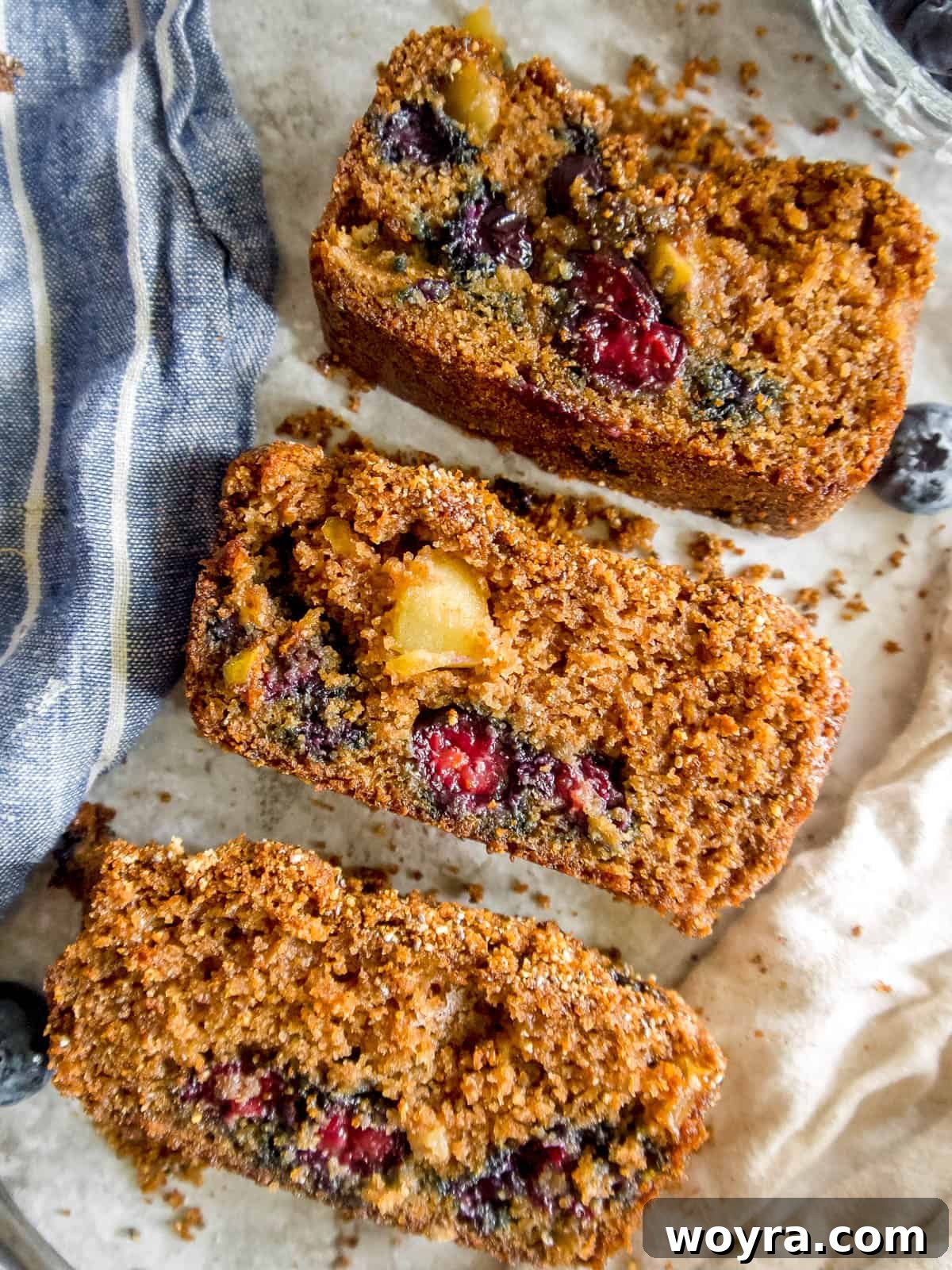 Guilt-Free Paleo Gluten-Free Apple Blueberry Loaf 4 Three perfectly golden-brown slices of almond flour blueberry bread arranged in a row.