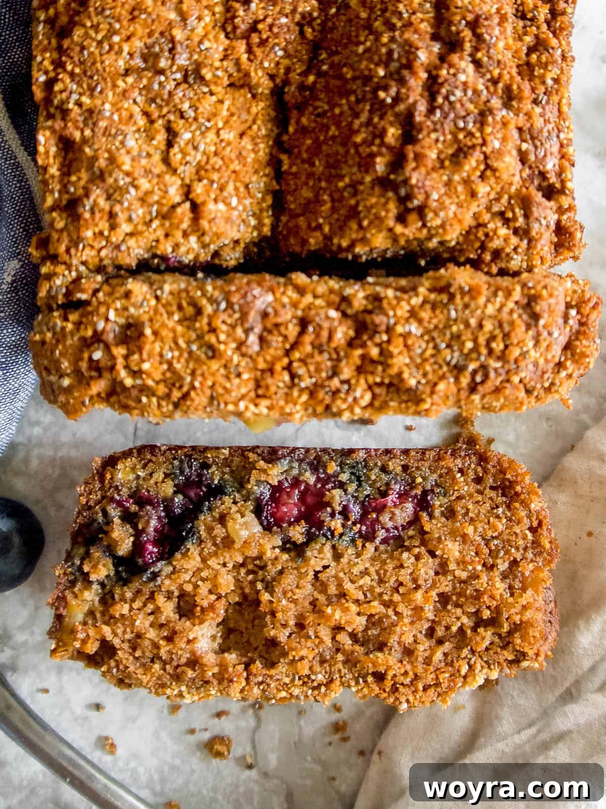 Guilt-Free Paleo Gluten-Free Apple Blueberry Loaf 5 A slice of freshly baked Paleo apple bread on a white plate, ready to be enjoyed.