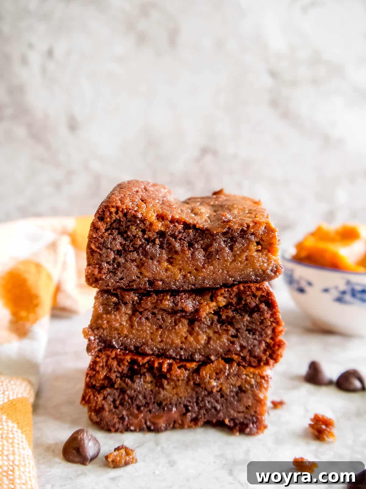 Fudgy Paleo Pumpkin Chocolate Brownies 3 Stack of four gooey Paleo pumpkin brownies, showcasing their rich texture and perfect swirl.