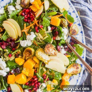 Fall harvest salad recipe in a large serving plate with a large spoon inside.