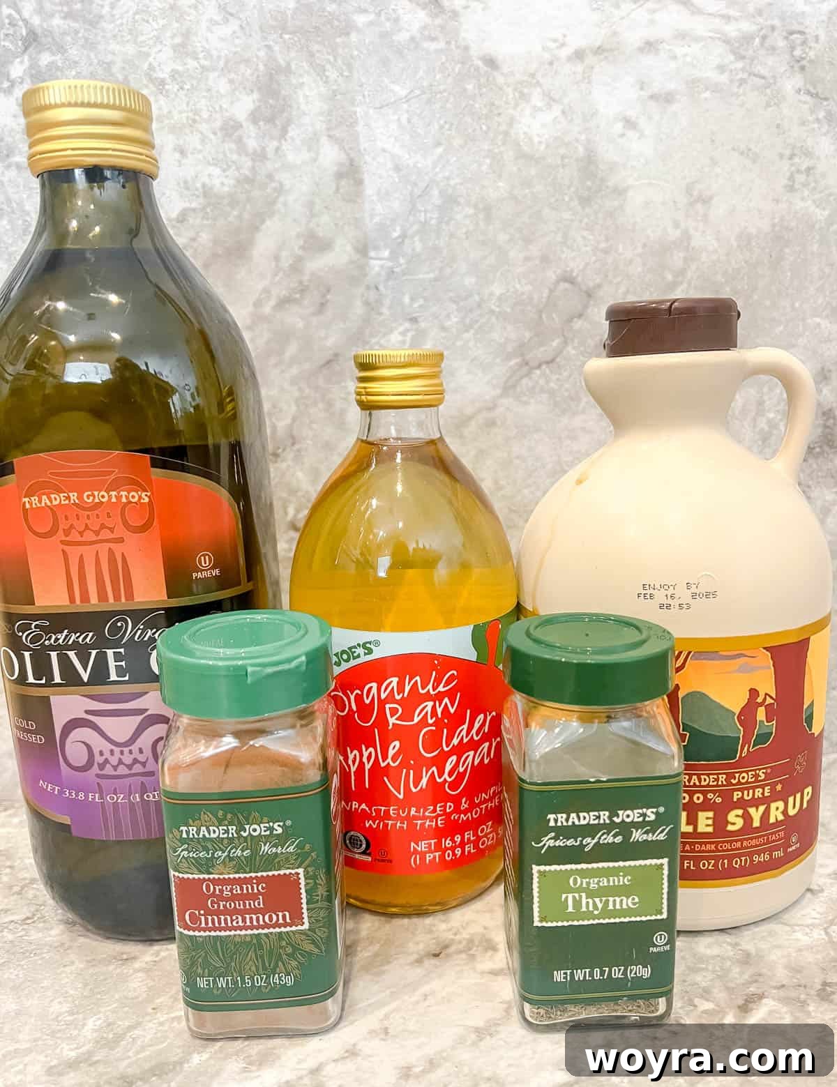 Maple Glazed Harvest Salad 4 Key ingredients neatly arranged for a homemade maple vinaigrette dressing, including olive oil, pure maple syrup, and tangy apple cider vinegar.