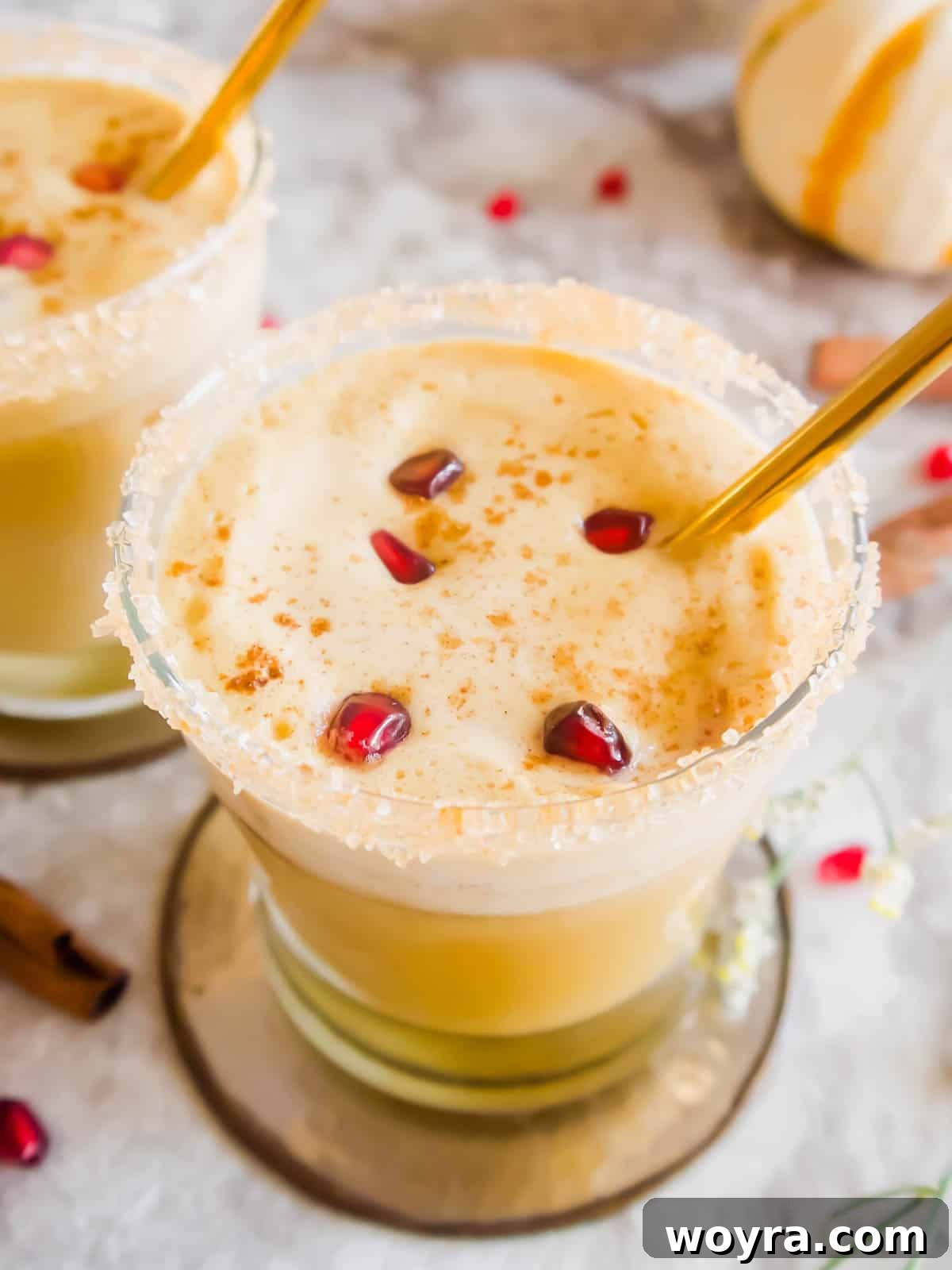 Fall white Russian in a cup with pomegranate seeds inside, evoking autumnal vibes.