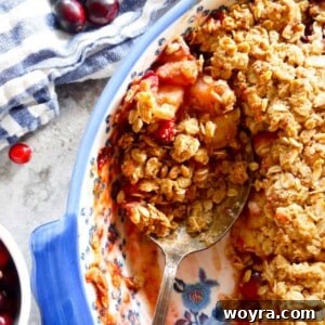 Spoon in baked pear oatmeal crisp.