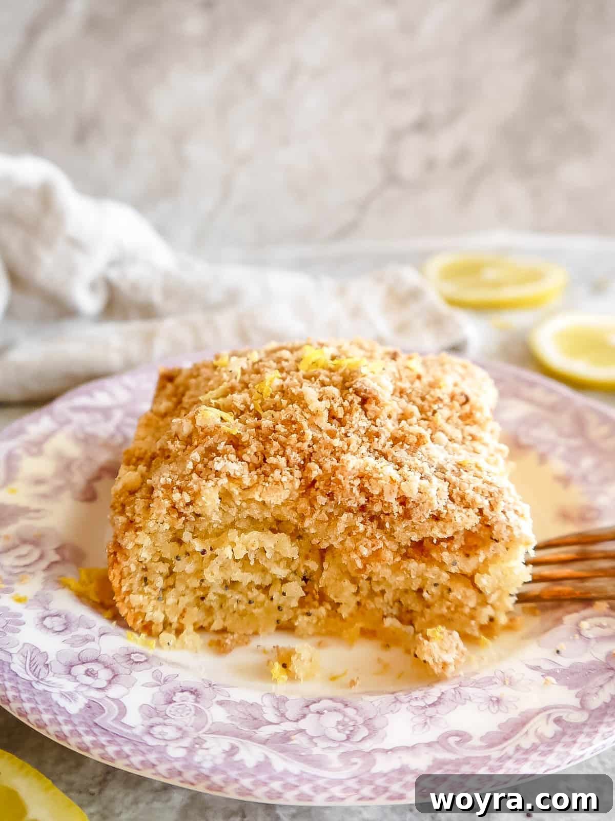 A whole Lemon Poppy Seed Coffee Cake on a decorative plate, beautifully glazed and ready for serving, with a soft, inviting glow.