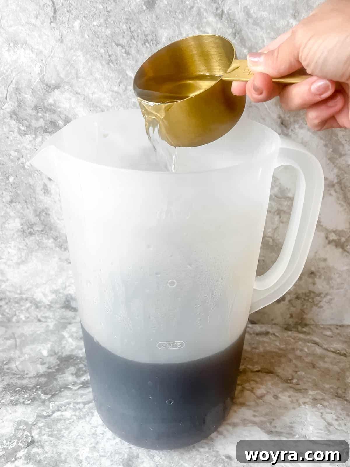 Cold water being poured into the maple-sweetened tea concentrate.