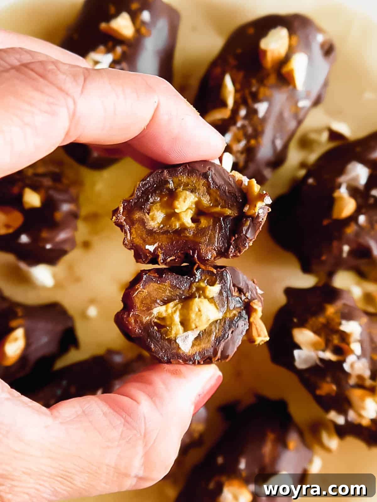 Pumpkin Spice & Chocolate Date Bites 3 A close-up of chocolate covered dates, cut in half to reveal the creamy pumpkin filling, showcasing the perfect balance of flavors.