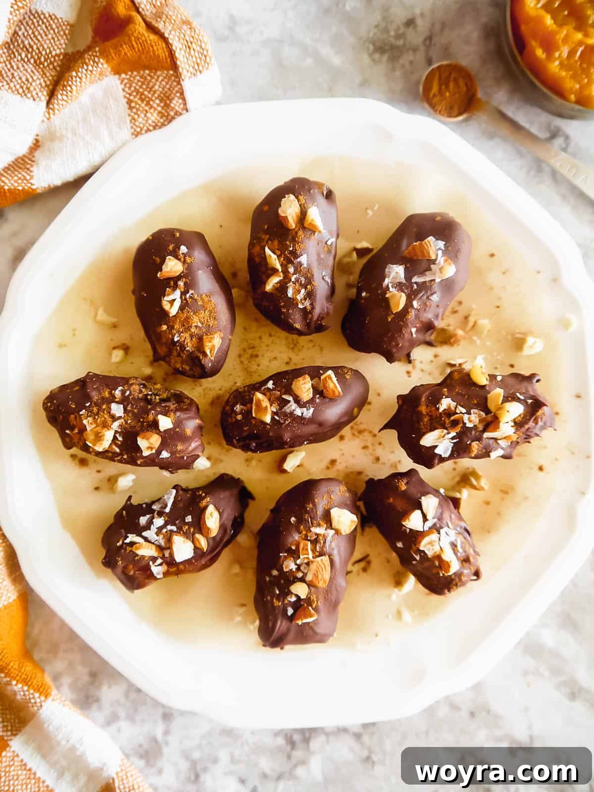 Pumpkin Spice & Chocolate Date Bites 5 Healthy pumpkin snickers-inspired dates arranged neatly on a plate, showcasing their delightful appearance and indicating they are ready to eat.