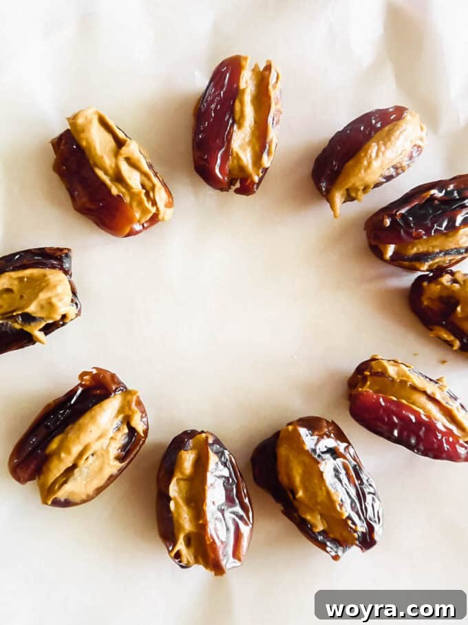 Pumpkin Spice & Chocolate Date Bites 8 Pitted Medjool dates carefully stuffed with the pumpkin sunflower seed butter mixture, ready for the chocolate coating.