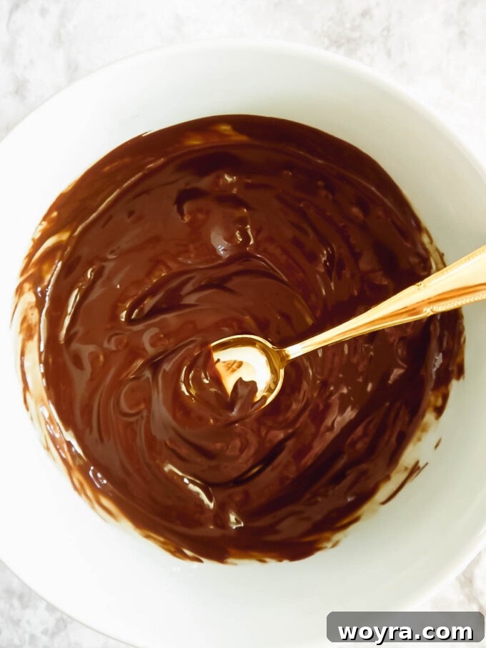 Autumn Spiced Chocolate Pumpkin Dates 9 A bowl of dairy-free chocolate chips, melted to a smooth, glossy consistency, ready for dipping.