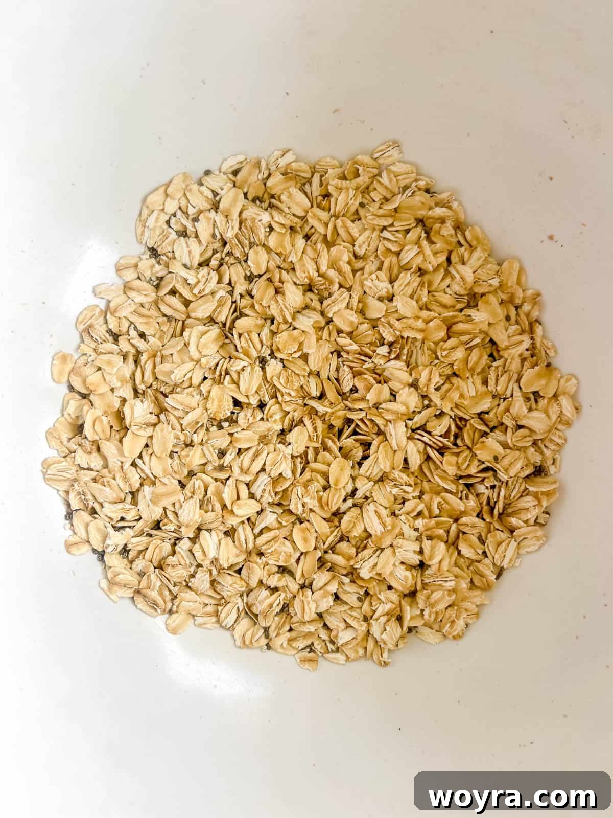 Rolled oats and chia seeds are combined in a mixing bowl.