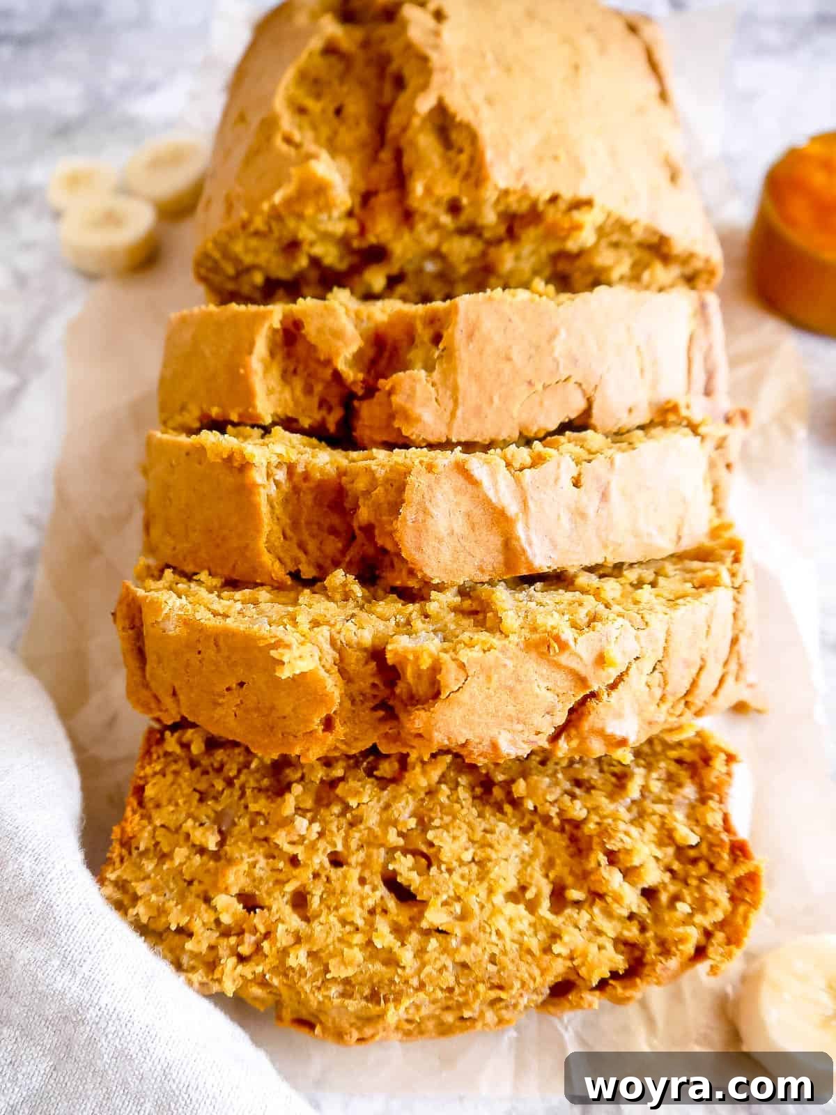 Wholesome Plant-Based Pumpkin Banana Bread 2 Healthy Pumpkin Banana Bread sliced on a table, showcasing its moist texture and rich color.