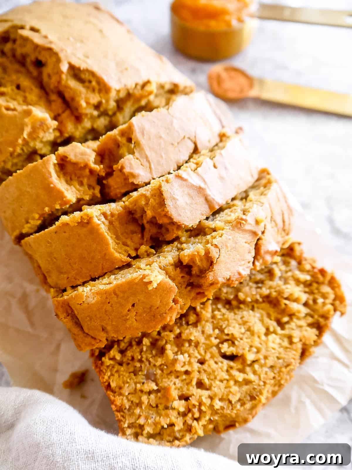 Wholesome Plant-Based Pumpkin Banana Bread 11 Side angle of healthy pumpkin banana bread recipe, showing the golden crust.