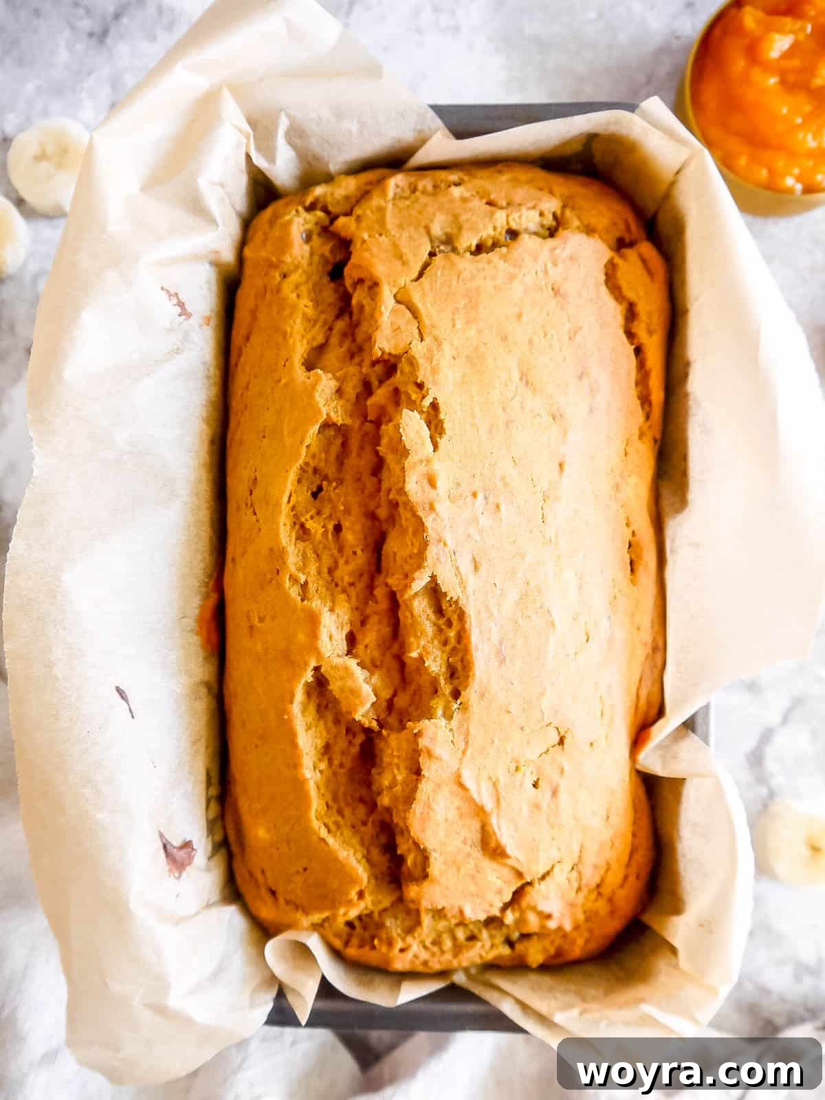 Wholesome Plant-Based Pumpkin Banana Bread 9 Baked pumpkin banana bread in the loaf pan, golden brown and perfectly risen.