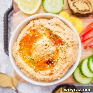 Creamy Mediterranean Cauliflower Hummus Paleo Gluten Free 9 Cauliflower hummus in a bowl with roasted eggplant and peppers inside.