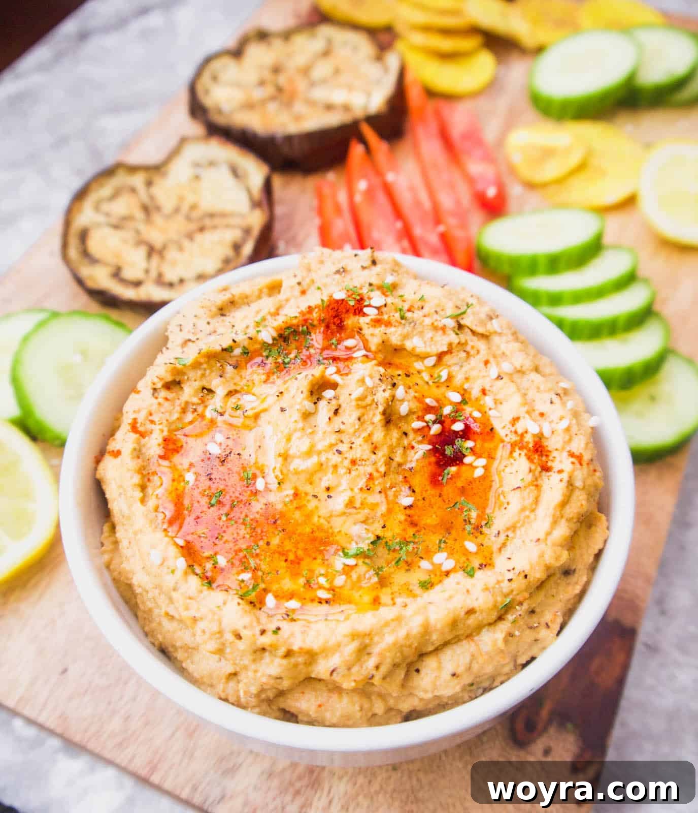 Creamy Mediterranean Cauliflower Hummus Paleo Gluten Free 3 A vibrant bowl of chickpea-free hummus, surrounded by a colorful array of fresh vegetables perfect for dipping.