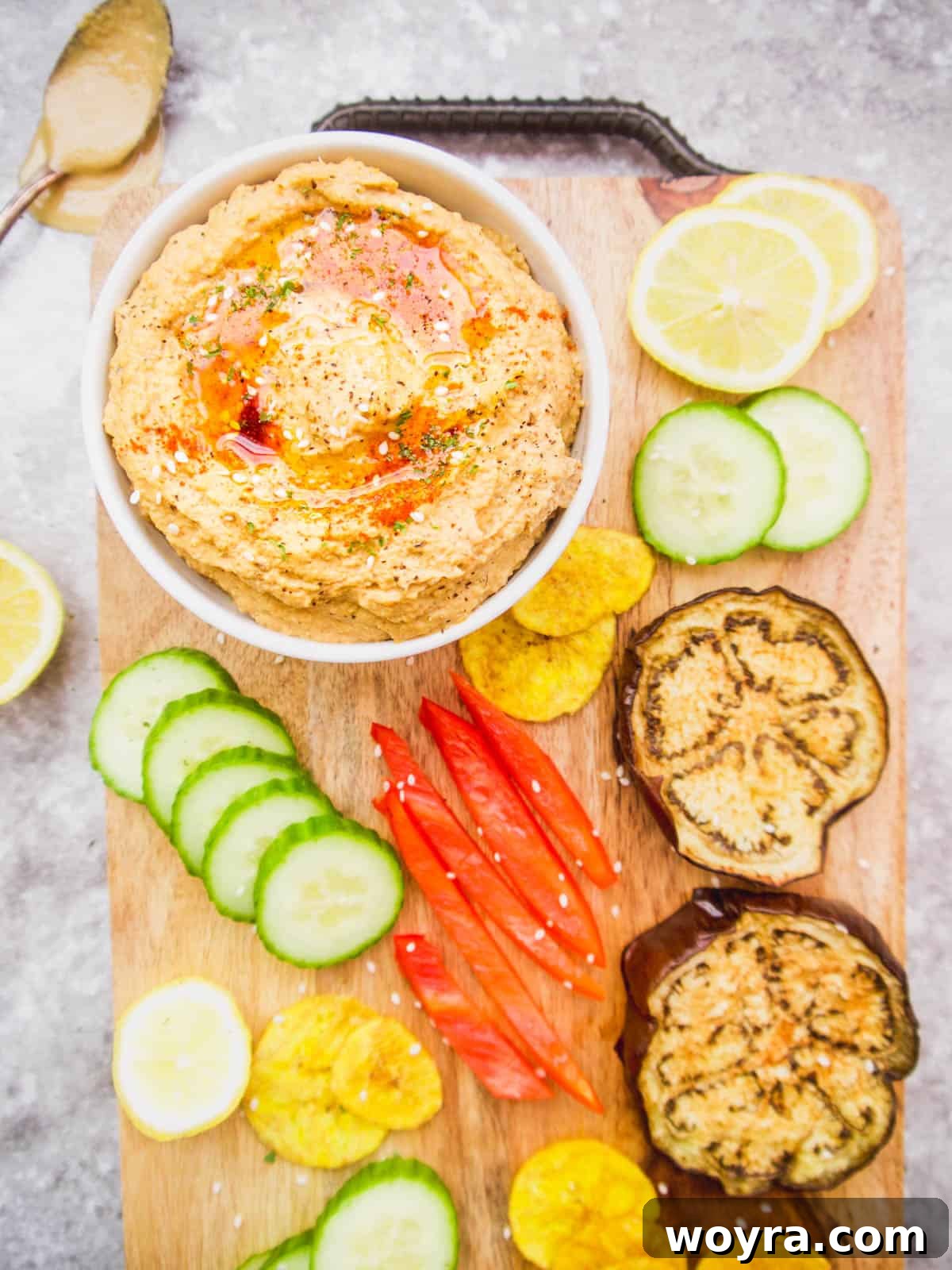 Paleo Mediterranean Cauliflower Dip 4 Paleo hummus on a serving tray with veggies and chips to dunk into it.