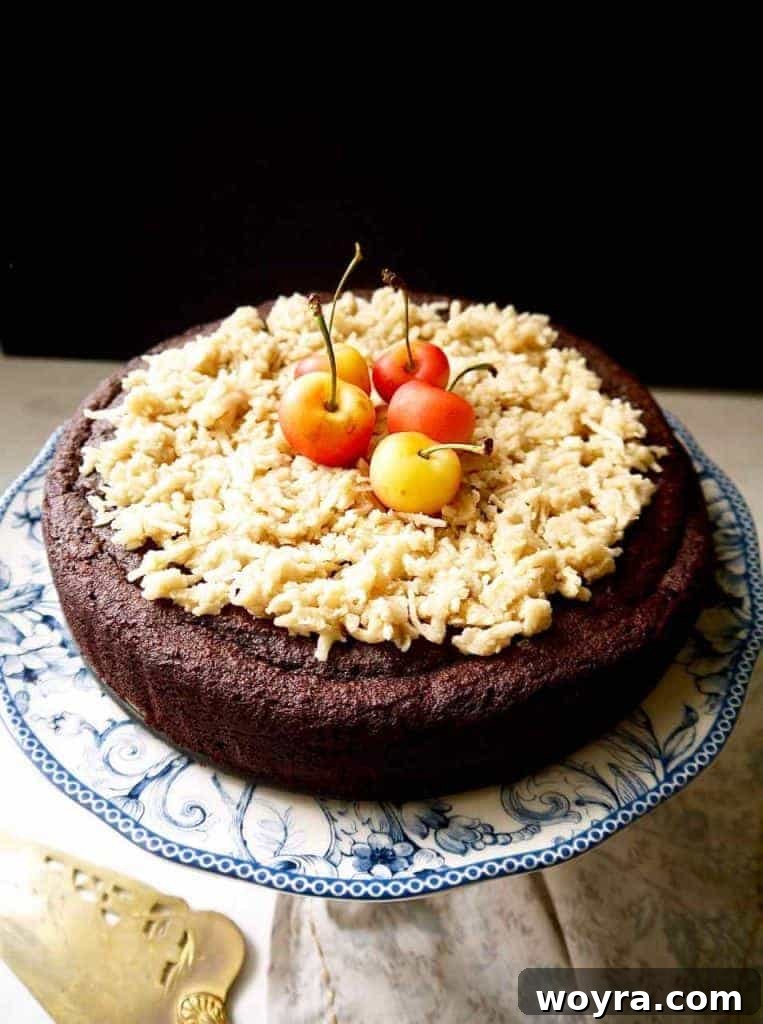 Paleo German Chocolate Cake 2 A beautifully frosted Paleo German Chocolate Cake with a rich caramel coconut topping, ready to be served. Gluten-free and dairy-free.