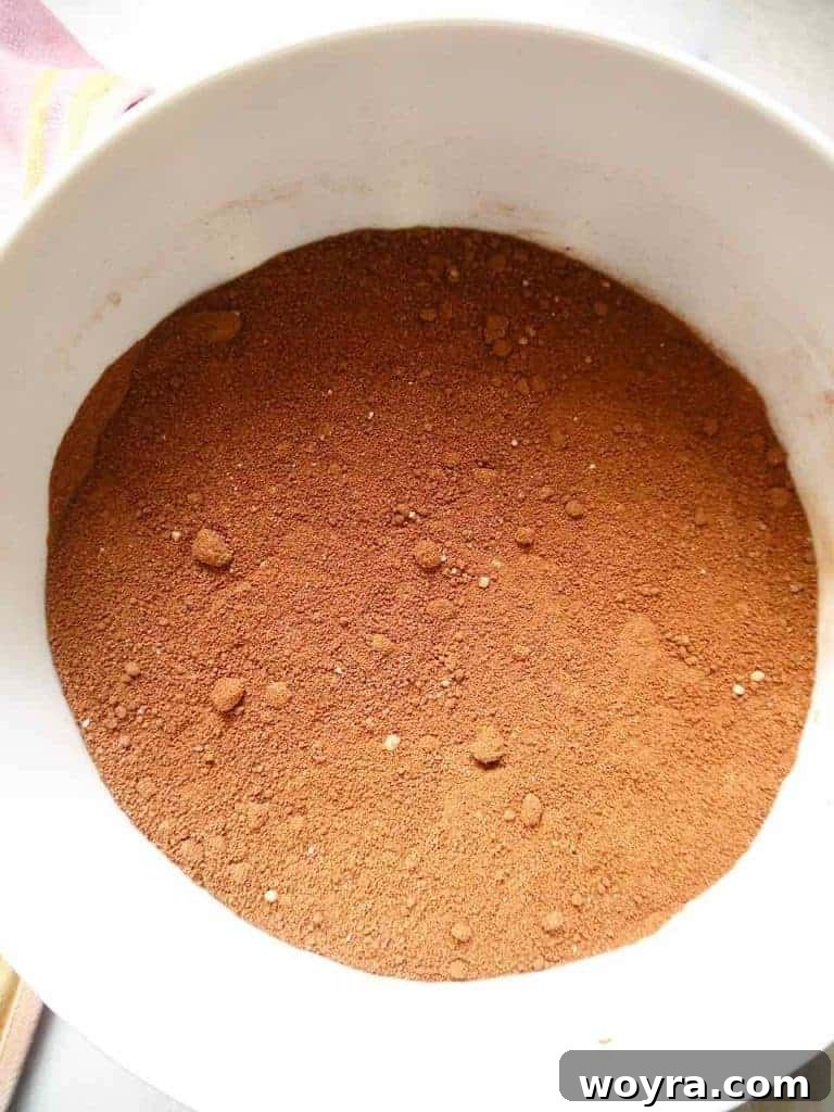 Paleo German Chocolate Cake 6 Dry ingredients for the Paleo German Chocolate Cake, including cocoa powder and flours, mixed in a bowl.