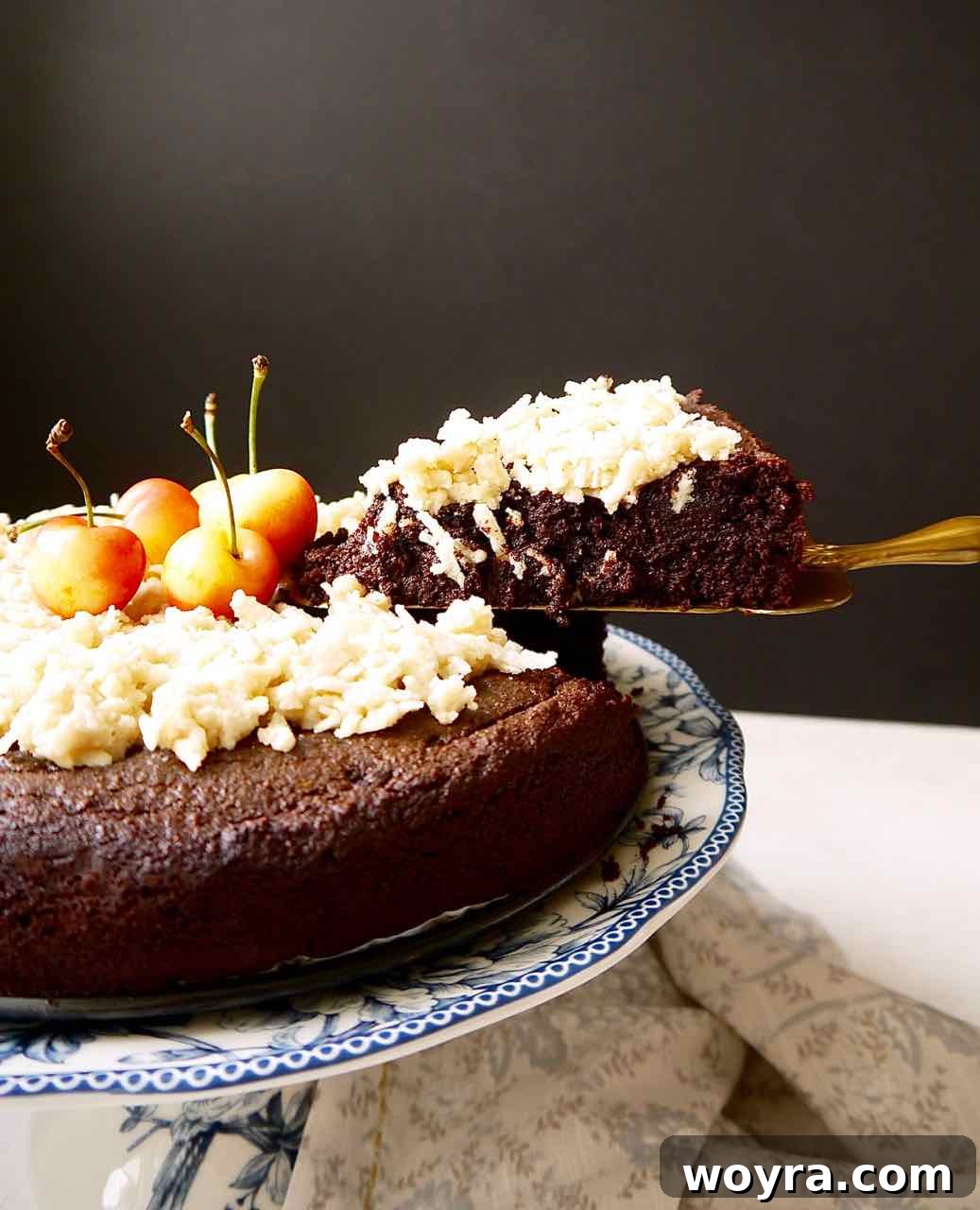 Paleo German Chocolate Cake 10 A slice of Paleo German Chocolate Cake, showcasing its moist interior and rich, textured caramel coconut frosting on top. Gluten-free and dairy-free dessert.