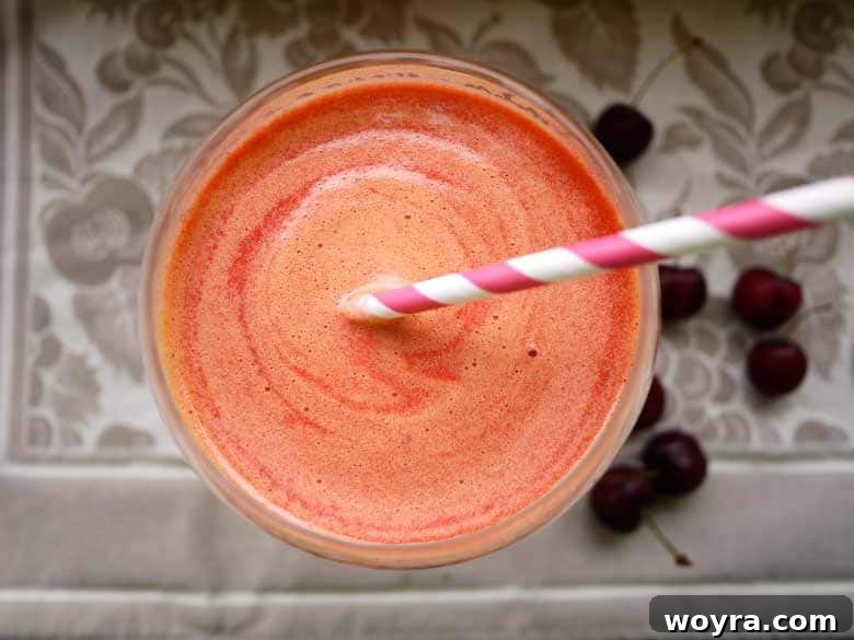 Ruby Lime Quencher 2 Vibrant red Sour Cherry-Lime Juice in a glass, with fresh cherries and lime slices on the side.