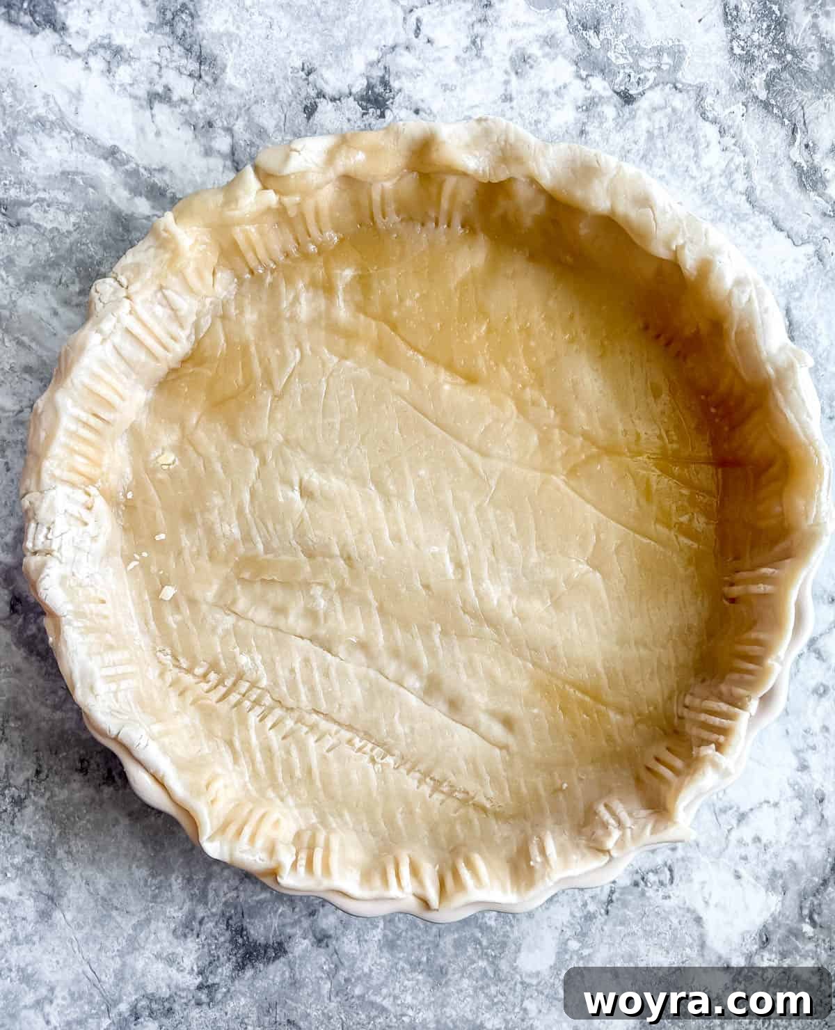 Effortless Apricot Tart 5 Store-bought pie crust pressed into the tart pan, edges fluted with a fork.