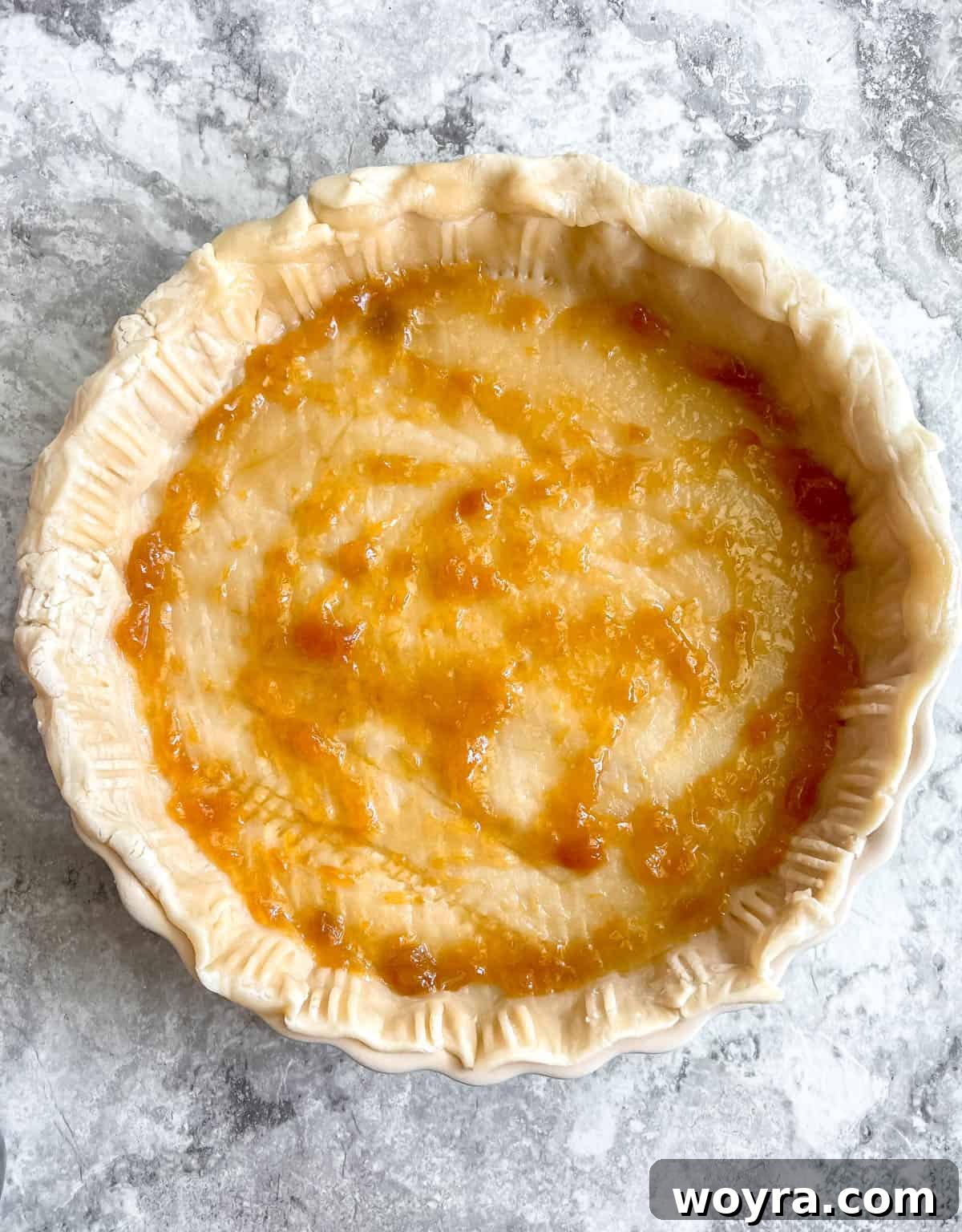 Effortless Apricot Tart 6 A smooth, even layer of apricot jam spread over the pie crust in the tart pan.