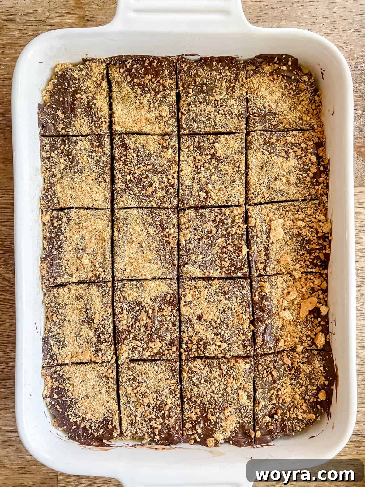 Campfire S'mores Krispie Bars 15 The S'mores Rice Krispie Treats are neatly cut into uniform squares, ready for serving after the chocolate has set.