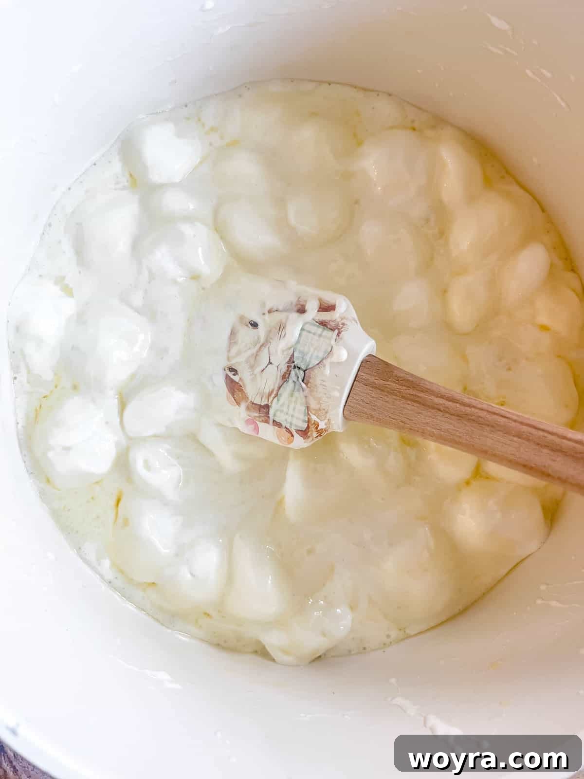 Campfire S'mores Krispie Bars 8 The marshmallows have fully melted into the butter in the saucepan, creating a smooth, gooey mixture ready for the crispy cereal.