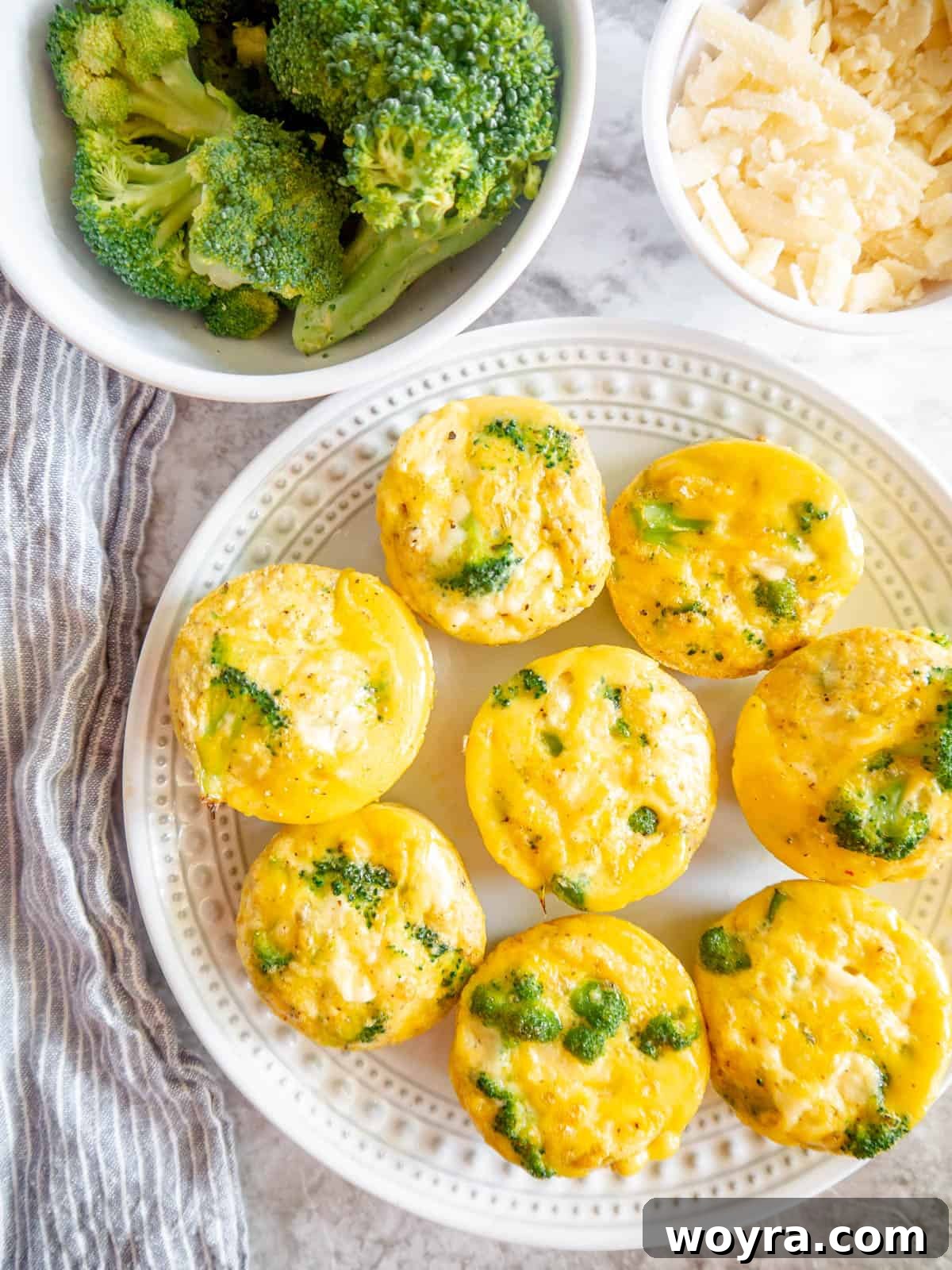 Two broccoli cheddar egg bites presented beautifully on a white plate, ready to be enjoyed.
