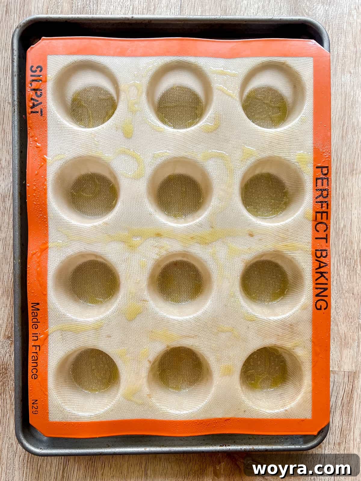 A silicone muffin pan freshly greased and ready for the egg mixture.