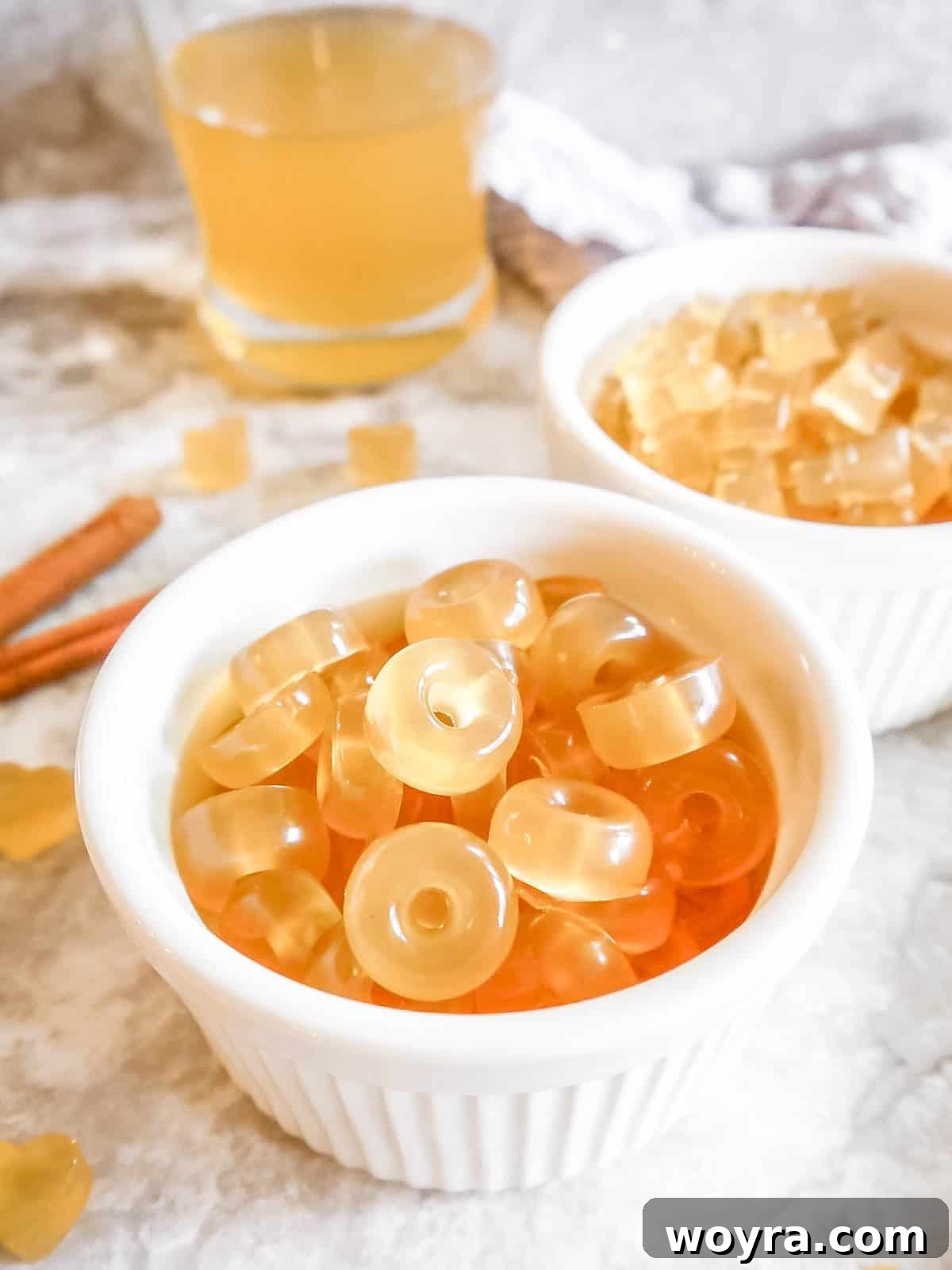 Orchard-Fresh Apple Gummy Bites 9 Two aesthetically pleasing bowls filled with a generous assortment of homemade gummy candies, made with gelatin and apple juice, highlighting their appealing texture and color.
