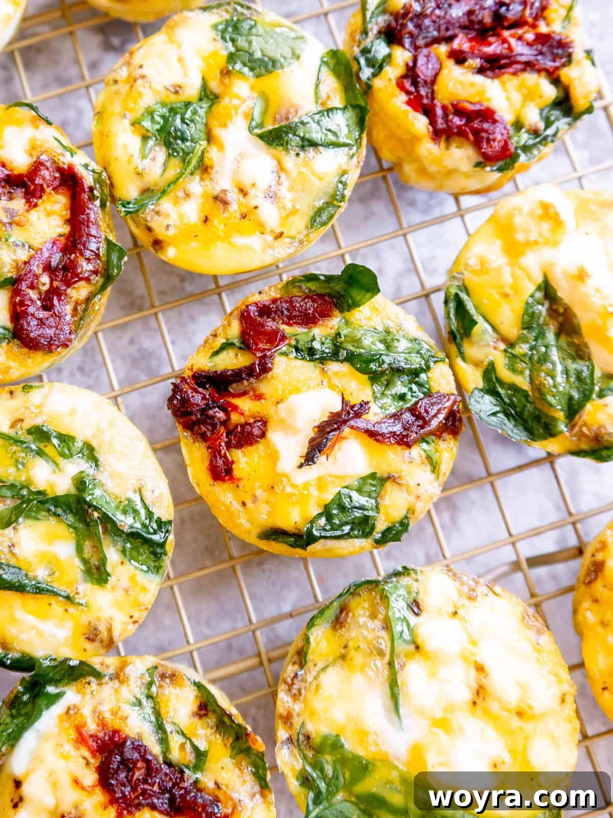 Spinach Feta Egg Bites 2 Freshly baked spinach feta egg cups cooling on a drying rack, ready to be enjoyed.