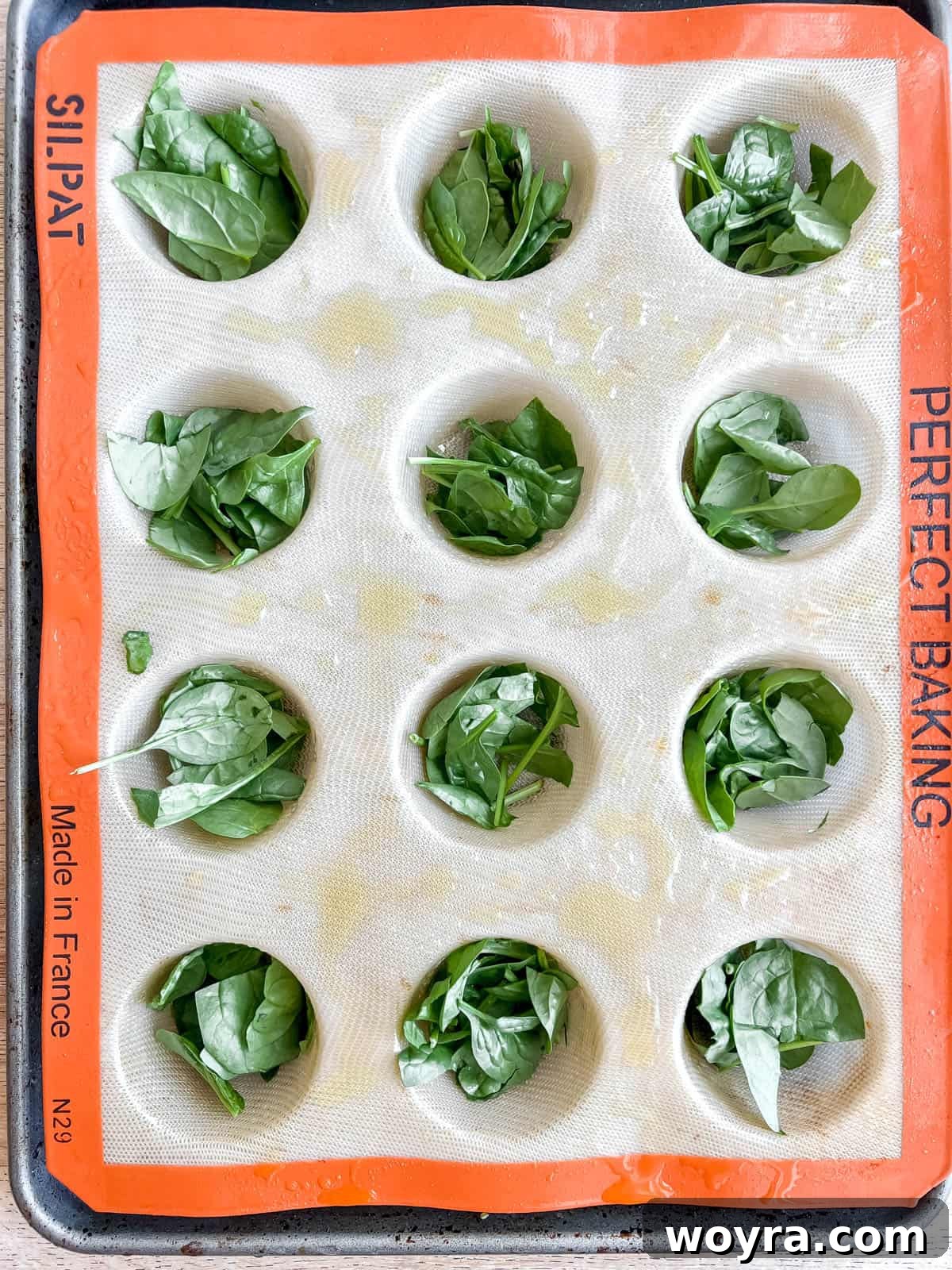 Spinach Feta Egg Bites 7 Finely chopped fresh spinach placed into individual muffin tin cups.