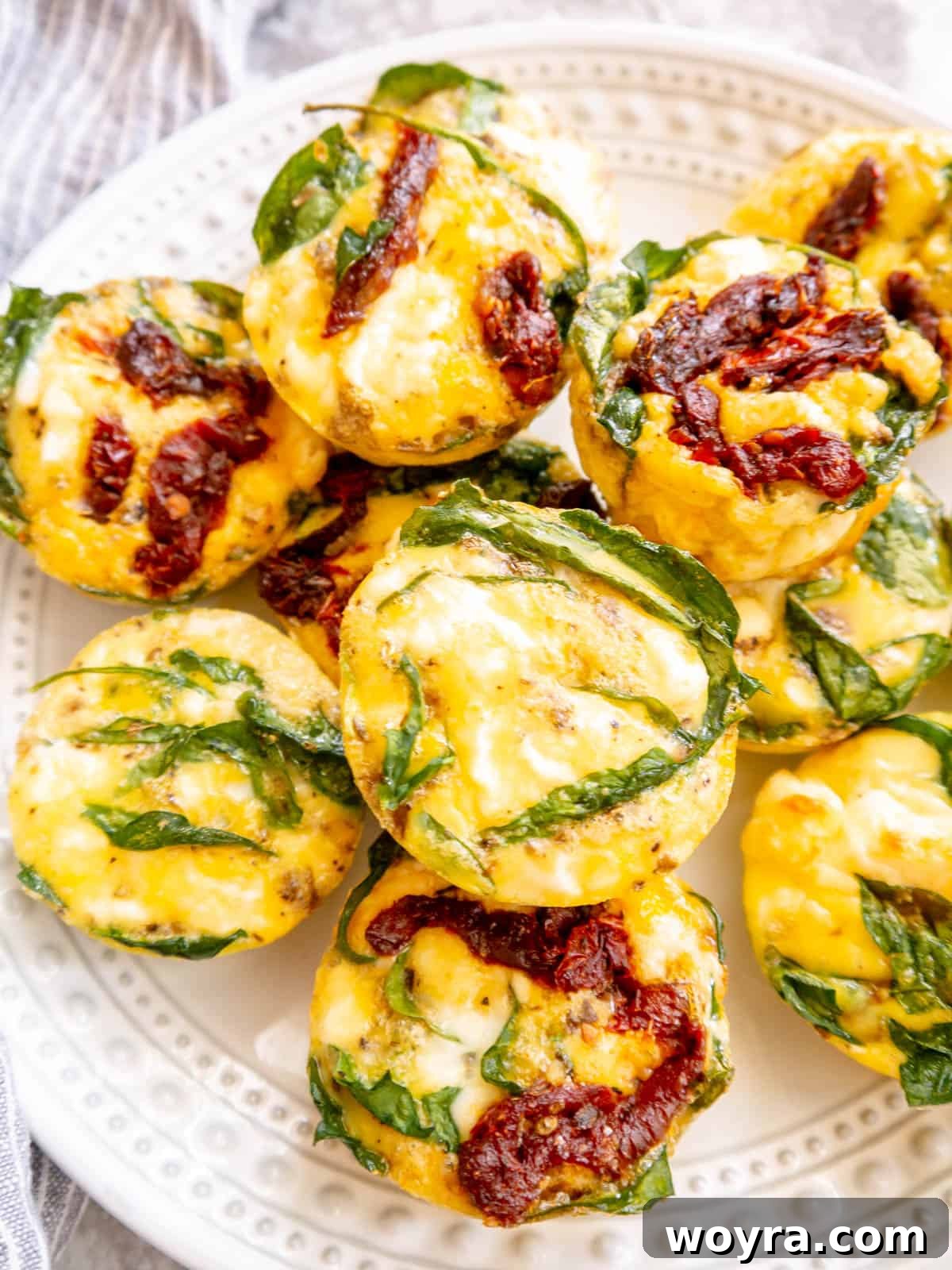 Spinach Feta Egg Bites 10 A plate of two spinach feta egg bites, ready to be served, highlighting their inviting texture.
