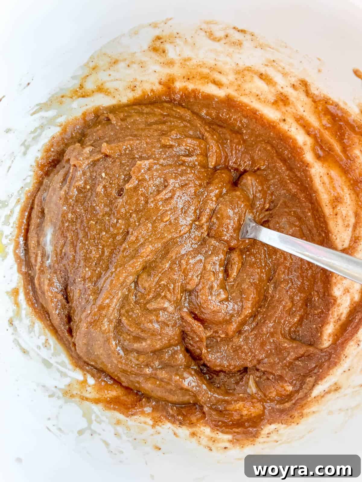 Giant Gluten-Free Flourless Almond Butter Cookies 6 Wet ingredients for flourless monster cookies (brown sugar, oil, eggs, vanilla, almond butter) mixed in a separate bowl.
