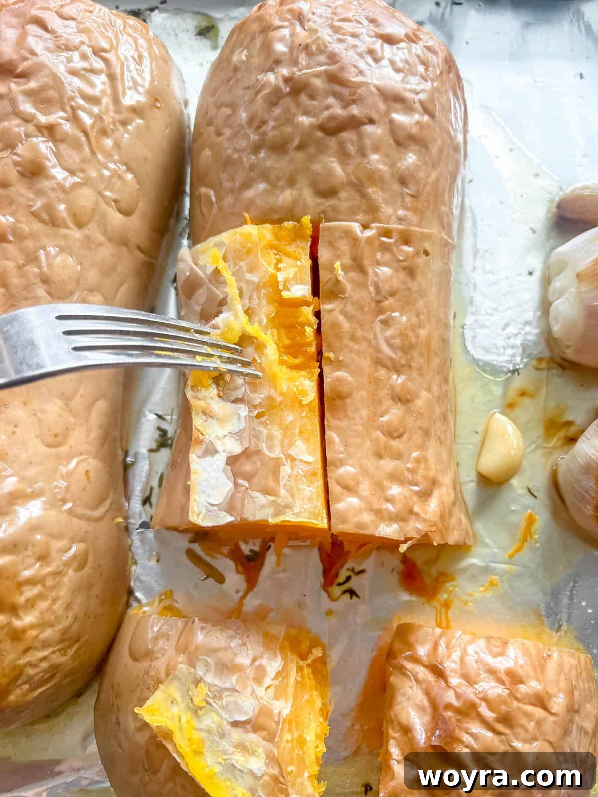Peeling the skin off roasted butternut squash.