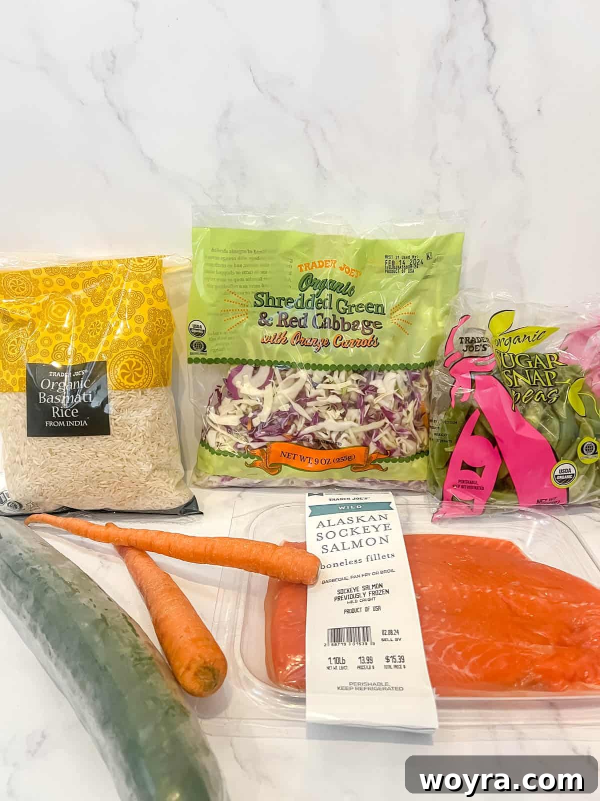 Dynamite Salmon Rice Bowl 3 All ingredients laid out for making the salmon rice bowl, including fresh salmon, rice, and various vegetables.