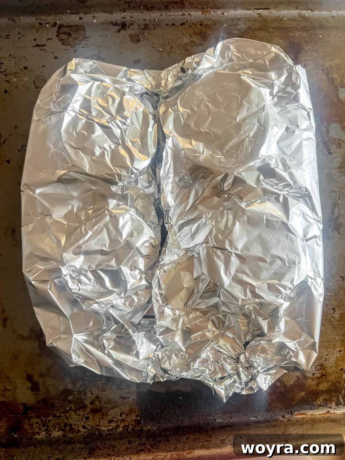 Dynamite Salmon Rice Bowl 9 Foil-wrapped salmon after cooking, appearing moist and ready to be served.