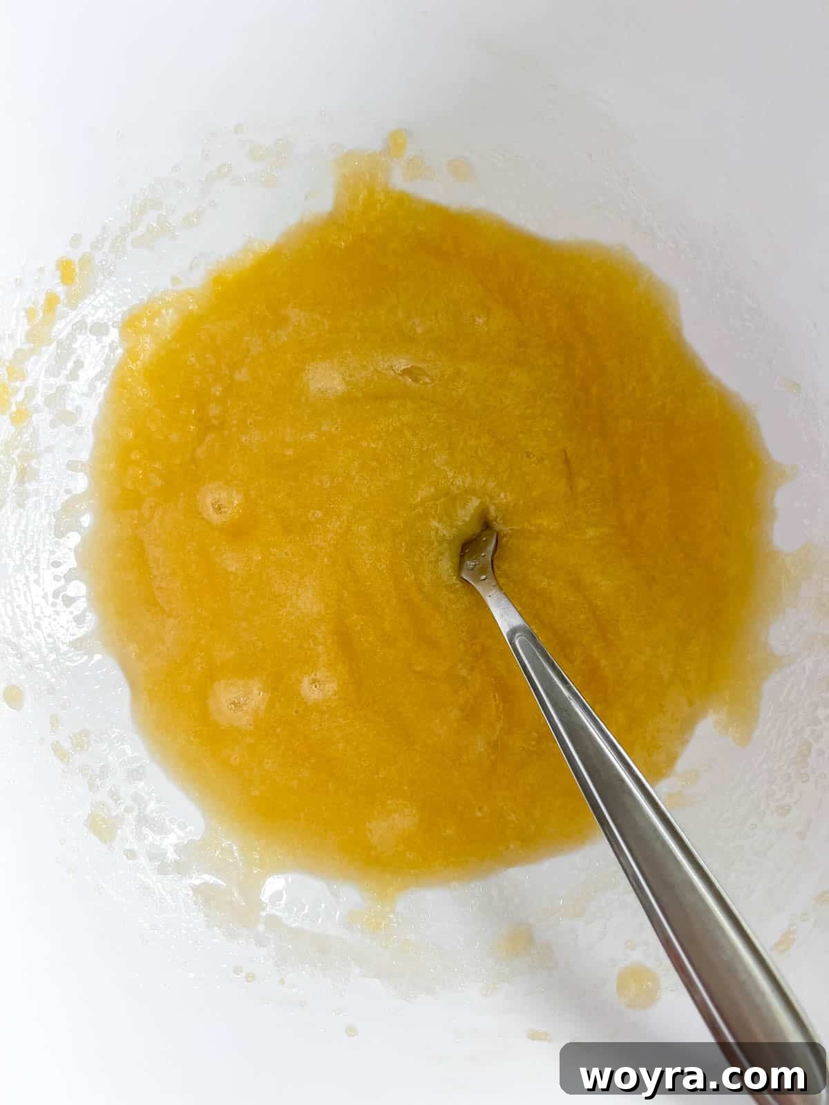 Wholesome Cottage Cheese Cookies 7 Egg and vanilla extract being added to the sugar and olive oil mixture.