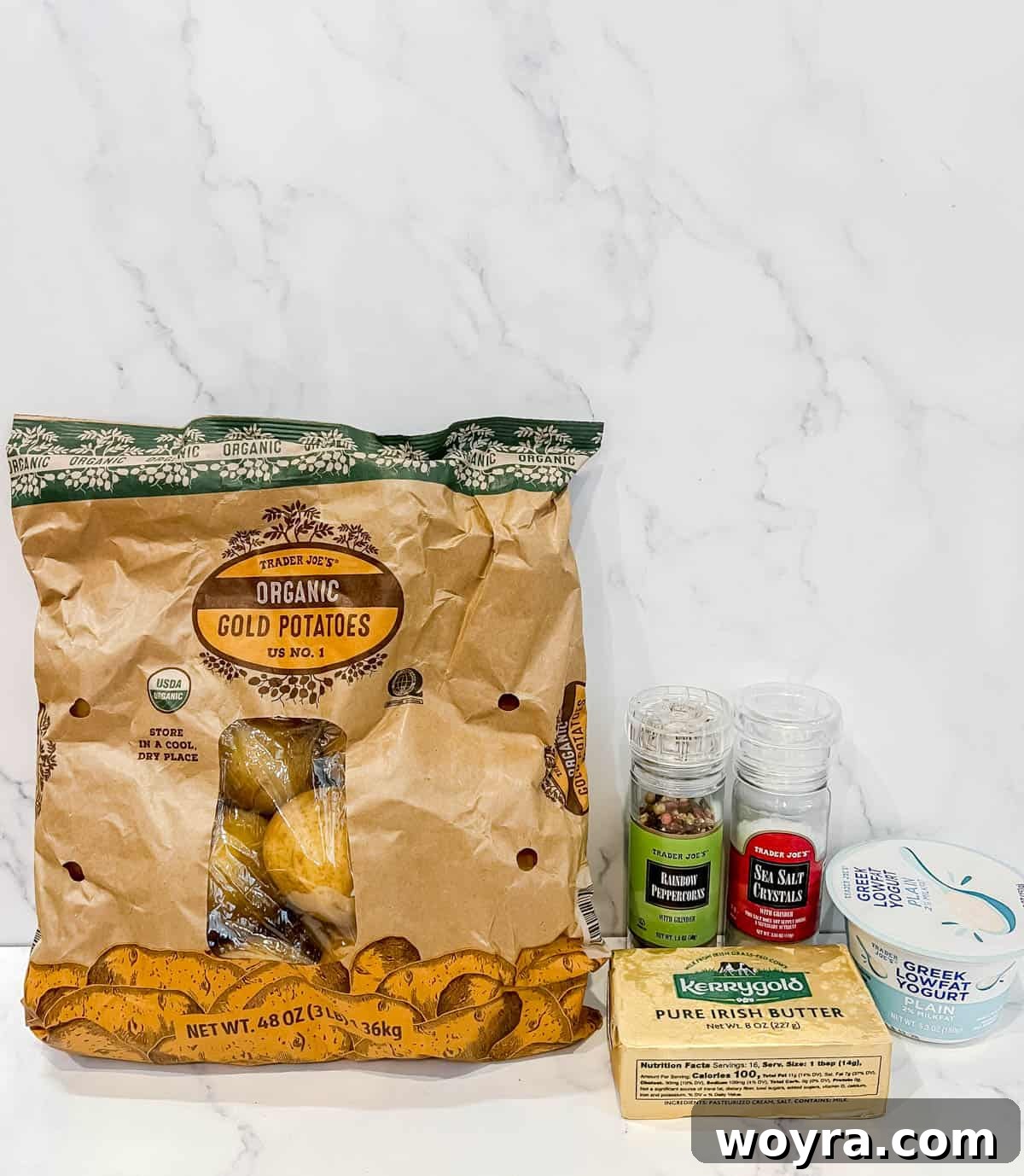 Ingredients needed to make Greek yogurt mashed potatoes, laid out on a kitchen counter.
