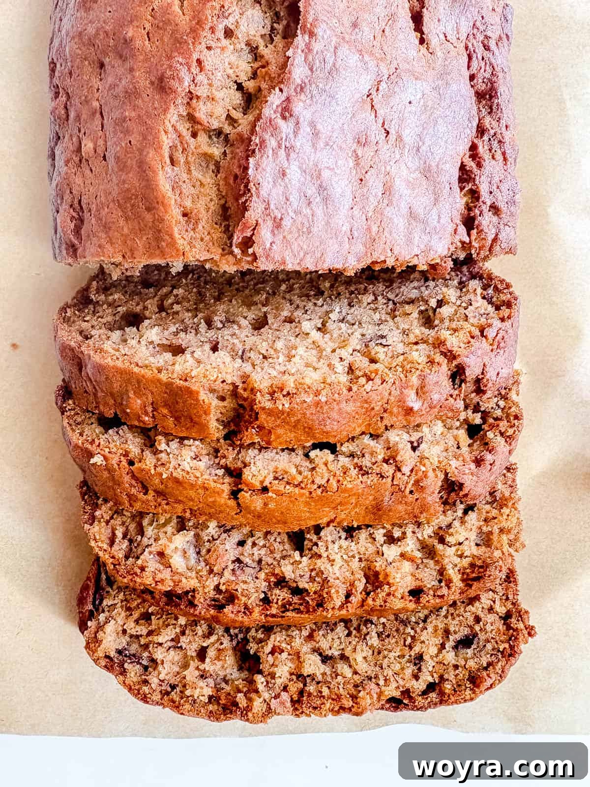 Mediterranean Banana Bread 9 Beautifully cut slices of dairy-free banana bread, made with healthy olive oil, arranged on a white serving plate.